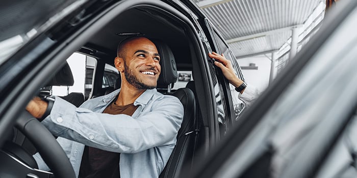 Dealer assisting a customer with their EV purchase