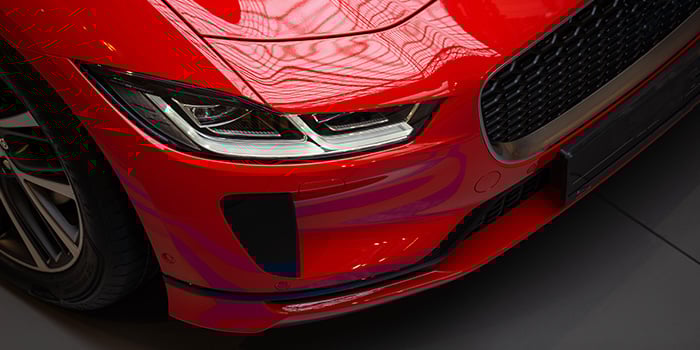 Close up shot of a shiny red vehicle